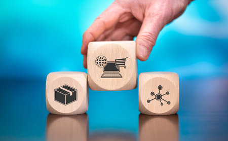 Wooden blocks with symbol of e-commerce concept on blue background