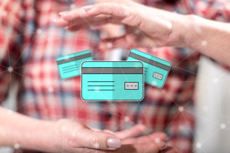 Credit card concept between hands of a woman in backgroundの写真素材