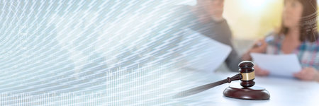 Divorce concept with judge gavel and couple reading documents in background, focus on foreground; panoramic bannerの写真素材