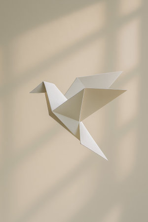A delicate origami bird gracefully suspended against a soft, neutral backdropの素材