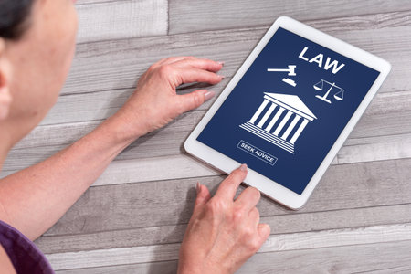 Woman using a tablet showing law concept