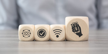 Wooden blocks with symbol of mobile payment conceptの写真素材