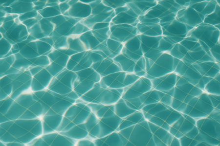 The serene surface of turquoise water reflecting light and showing gentle ripplesの素材