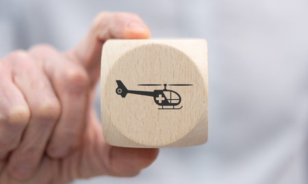 Hand holding a wooden cube with symbol of emergency conceptの写真素材