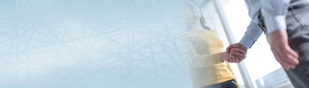 Businesswoman and businessman shaking hands in office; panoramic bannerの写真素材