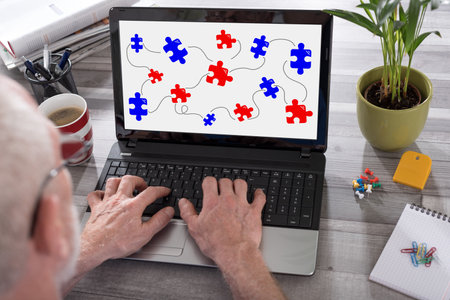 Teamwork concept shown on a laptop used by a manの写真素材