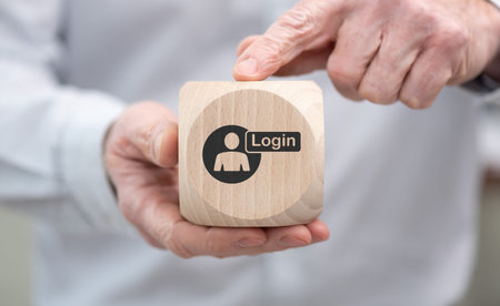 Hand holding a wooden cube with symbol of login conceptの写真素材