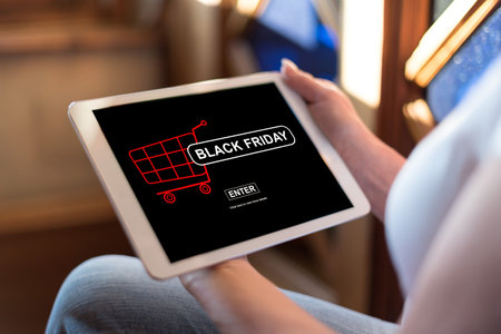 Woman holding a tablet showing black friday conceptの写真素材