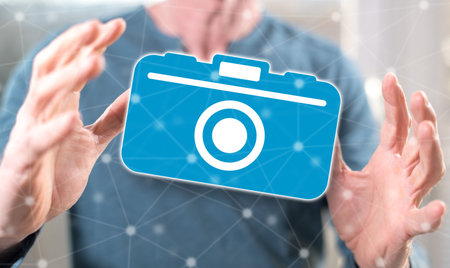 Photography concept between hands of a man in backgroundの写真素材