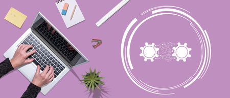 Top view of hands using laptop with symbol of machine learning conceptの写真素材