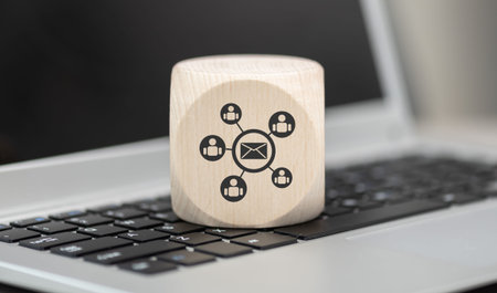 Wooden block with symbol of email marketing concept on laptop keyboardの写真素材