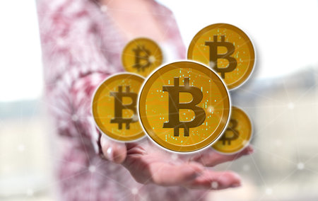 Bitcoin concept above the hand of a woman in backgroundの写真素材