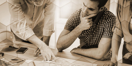 Architects working on plans at office, light effect, geometric patternの写真素材