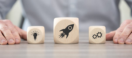 Wooden blocks with symbol of business startup concept