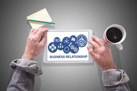 Male hands using a tablet showing business relationship conceptの写真素材