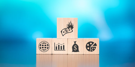 Wooden blocks with symbol of inflation concept on blue backgroundの写真素材