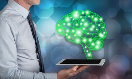 Artificial intelligence concept above a tablet held by a manの写真素材