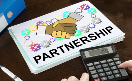Partnership concept illustrated on a paper with a calculatorの写真素材