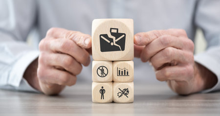 Wooden blocks with symbol of job loss conceptの写真素材