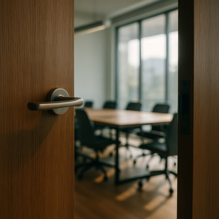 An open door revealing a modern conference room with a large table and chairs insideの素材