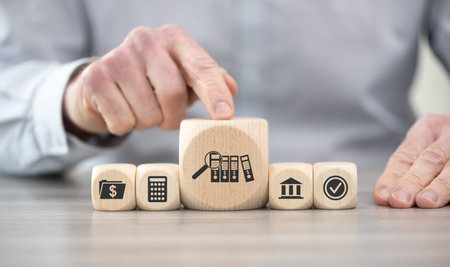 Wooden blocks with symbol of financial audit conceptの写真素材