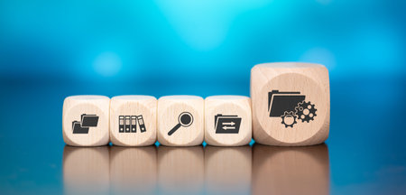 Wooden blocks with symbol of document management concept on blue backgroundの写真素材