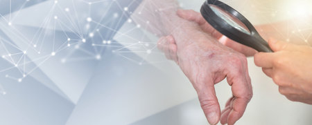 Dermatologist examining skin of patient hand with magnifying glass; panoramic bannerの写真素材