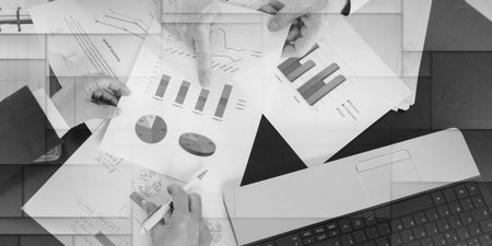 Businesspeople having a discussion about financial report at office, geometric pattern