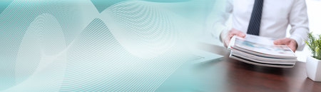 Hands of businessman holding magazines; panoramic banner