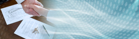 Estate agent shaking hands with his customer after contract signature; panoramic bannerの写真素材