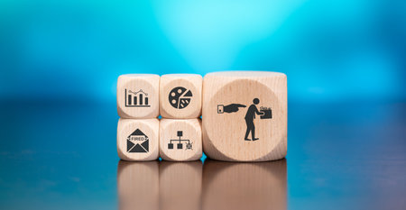 Wooden blocks with symbol of job loss concept on blue backgroundの写真素材