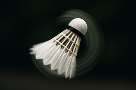 A close-up of a shuttlecock in motion, showcasing its dynamic spinning and elegant designの素材