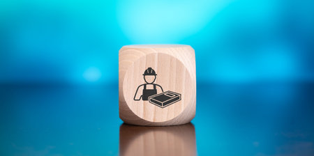 Wooden block with symbol of continuing education concept on blue background