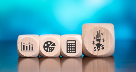Wooden blocks with symbol of financial crisis concept on blue backgroundの写真素材