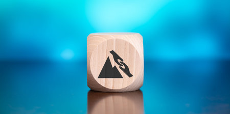 Wooden block with symbol of trust concept on blue backgroundの写真素材