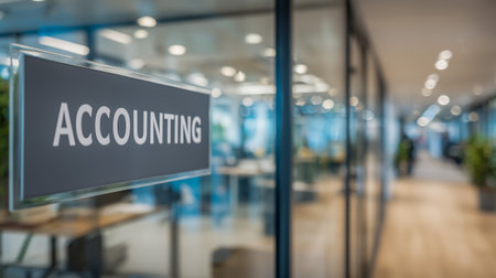 An office space featuring a clear accounting sign with a blurred, modern workspace behind itの素材