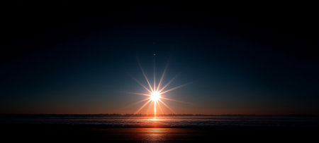 A beautiful sunset with rays reflecting over the tranquil surface of the oceanの素材