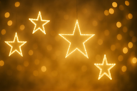 Four glowing stars create a warm and festive atmosphere with a beautiful golden backgroundの素材