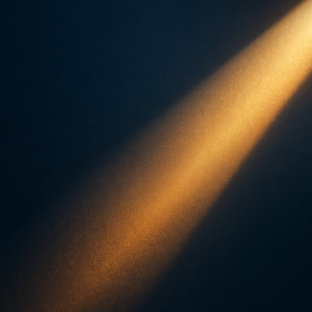 A beautiful golden light beam casts across a dark surface, creating an abstract effectの素材