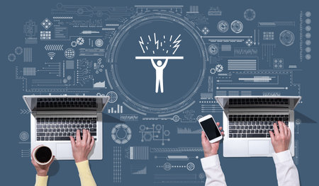 Top view of hands using laptop with symbol of crisis management conceptの写真素材