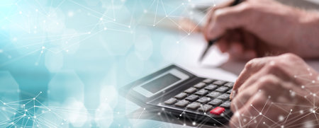 Male hand using calculator, accounting concept; panoramic banner