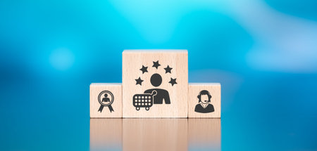 Wooden blocks with symbol of customer loyalty concept on blue backgroundの写真素材