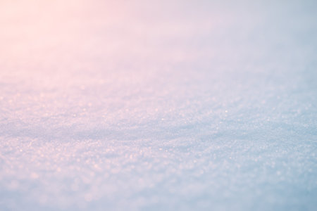 A close-up view of soft snow texture illuminated by gentle pastel shades of lightの素材