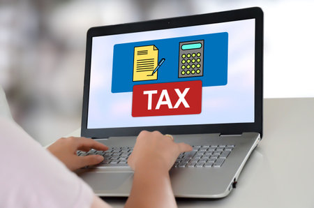 Woman using a laptop with tax concept on the screen