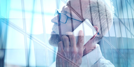 Senior man talking on mobile phone, double exposure, light effect, geometric patternの写真素材