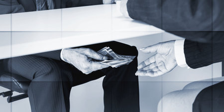Businessman giving money under a tableの写真素材