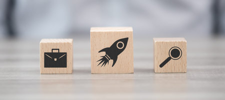 Wooden blocks with symbol of business startup concept