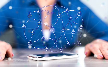 Smartphone with social network concept between hands of a woman in background