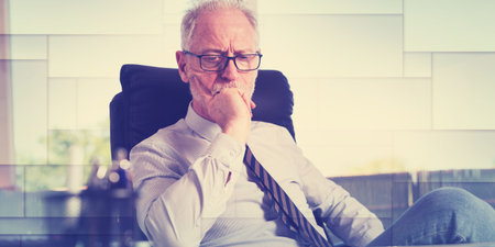 Portrait of thoughtful businessman sitting in office, geometric pattern