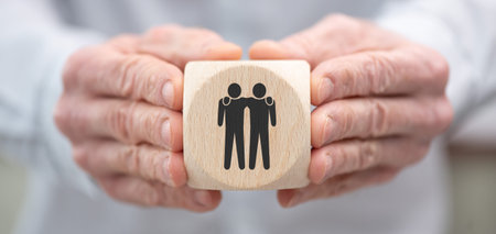 Hand holding a wooden cube with symbol of friendship conceptの写真素材